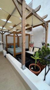 a patio with a bed and potted plants at AMMO in Olhão