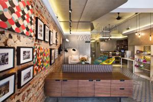 a living room with a brick wall at Hotel 1000 Miles in Kuala Lumpur