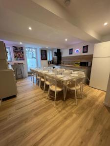 a room with a long table with chairs and a kitchen at Arcade & Gaming Lodge in Trans-en-Provence +41 photos