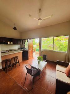 a living room with a couch and a table at Villas victoria mirador in Zihuatanejo