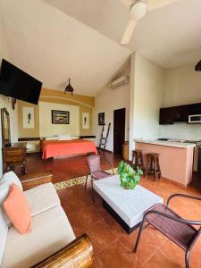 a living room with a bed and a couch at Villas victoria mirador in Zihuatanejo