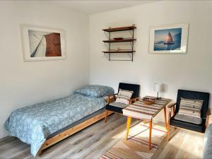 a bedroom with a bed and a table and a chair at Alma2 Vendégház in Révfülöp
