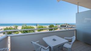 a table and chairs on a balcony with the beach at Nuovo Hotel SettiBi in Giulianova