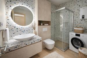 a bathroom with a sink and a washing machine at Block and Svemir Suiets in Kumanovo