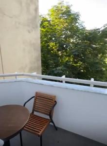 a chair and a table on a balcony at Block and Svemir Suiets in Kumanovo