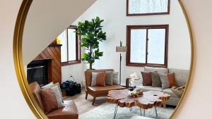 a living room with a table and a mirror at Blackwood Cabin Pocono in Pocono Farms East +36 photos