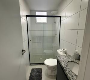 a bathroom with a shower and a toilet and a sink at Fátima Prime Loft + Breakfast in Extrema +36 photos