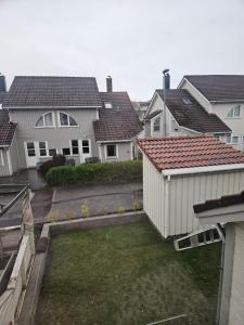 a view of a yard with houses at Cozy 3-Bedroom Home in Forus in Stavanger