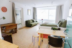 a living room with a couch and a table at raum life - Design Apartment mit Küche in der Altstadt in Regensburg