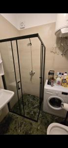 a shower in a bathroom with a washing machine at Star Residence in Tirana