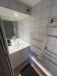a bathroom with a sink and a mirror at Moulin Cottage - Germaines in Germaines +20 photos