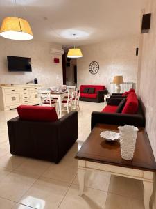 a living room with two couches and a table at B&B Sud Est in Carmiano