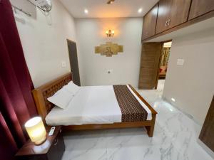 a small bedroom with a bed in a room at Sri Apartment Homestay 2BHK Pondicherry A2 in Pondicherry