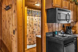 a kitchen with a sink and a microwave at Mountain View Cabins in Tellico Plains +94 photos
