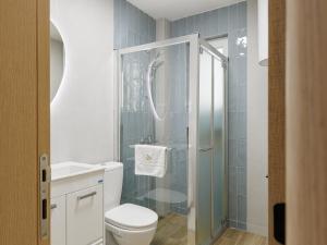 a bathroom with a toilet and a glass shower at Avenue Apartments Ilinden in Ilinden +62 photos