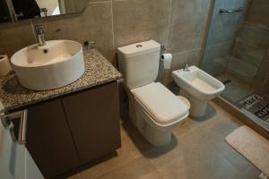 a bathroom with a toilet and a sink at Hotel alamos de la puntilla in Belén +48 photos
