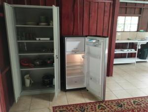 a refrigerator with its door open in a kitchen at Maison tranquille in Rivas