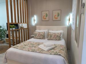 a bedroom with a bed with towels on it at Lucas House in Nazaré