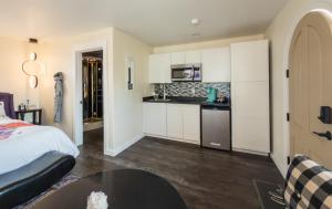 a kitchen with white cabinets and a table in a room at EO Bungalows, Black Hills in Custer