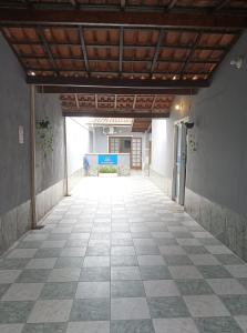 an empty hallway of a building with a tile floor at Recanto Mosaico in São Sebastião