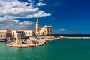 a group of buildings on a pier in the water at Piazzetta 42 Holiday Room in Trani
