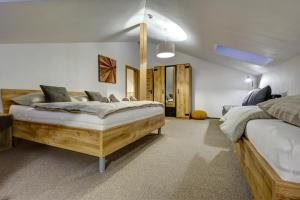 a bedroom with two beds in a room at TRIA House Liptov in Ižipovce +51 photos