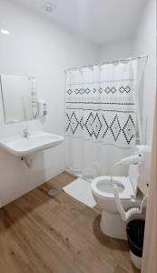 a white bathroom with a toilet and a sink at AYZ Joaquín Pol - Auto check-in property in Madrid