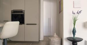 a kitchen with a refrigerator and a table and a chair at Casabaja in Baja Sardinia +5 photos