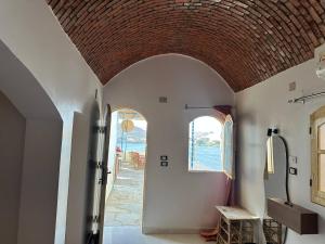 a hallway of a house with an arched doorway at Queen House in Aswan