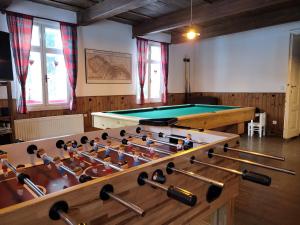 a room with a pool table and cues at Chalupa U Bertholda in Červená Voda