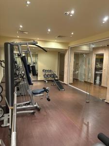 a gym with several tread machines in a room at Chamkoria Forest apartment in Borovets