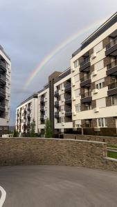 a rainbow in the sky over some buildings at Bagdala apartman Krusevac in Kruševac