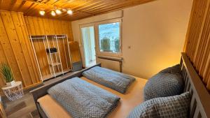 a bedroom with two beds and a window at Gemütliche Auszeit in Burg