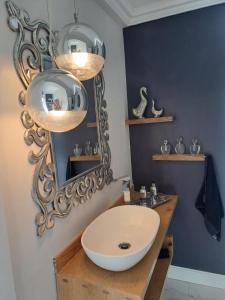 a bathroom with a white sink and a mirror at Boutique Inn - Azure in Gordonʼs Bay