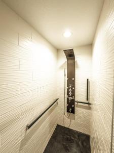 a walk in shower in a room with white walls at EO Bungalows, Black Hills in Custer +27 photos