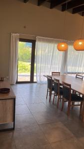 a dining room with a table and chairs at Límite Sur Lodge in Trevelín +34 photos