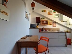 a kitchen with a wooden table and a table and a counter at La Mansarda delle Mongolfiere in Turin