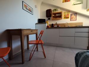 a kitchen with a counter and a table and a table at La Mansarda delle Mongolfiere in Turin +42 photos