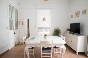 a white dining room with a white table and chairs at ABCyou Bed&Breakfast in Valencia +95 photos