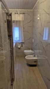 a white bathroom with two toilets and a shower at H(a)ver as Faias in Manteigas +27 photos