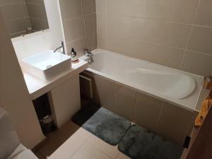 a bathroom with a sink and a bath tub at KDS appartement T2 Île de la Réunion in Saint-Denis +9 photos