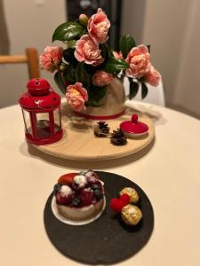 a table with two plates of food on a table with flowers at Casinha Serabigoes Arouca Passadiços Paiva in Arouca
