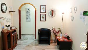 a living room with a black chair and a table at Anastasia's Apartment ΛΑΥΡΙΟ in Lavrio +14 photos