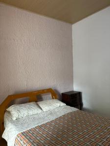 a bedroom with a bed and a night stand at MonSua in San Luis