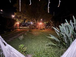 a garden at night with a fence and lights at MonSua in San Luis +5 photos