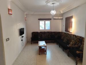 a living room with a couch and a table at Dar Karim in Midoun