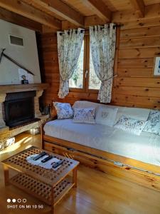 a bedroom with a large bed in a log cabin at Chalet Le Gentiane in Bun