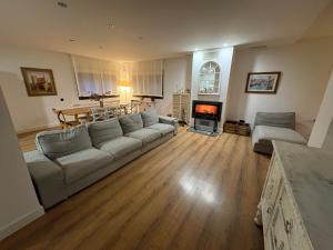 a living room with a couch and a fireplace at Finca Alboroto in Huesca