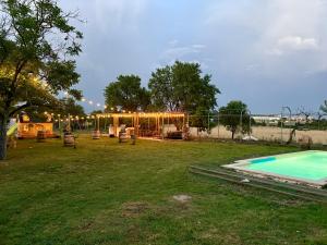 a yard with a playground and a swimming pool at Finca Alboroto in Huesca