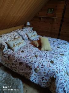 a bed with a happy anniversary pillows on it at Chalet Le Gentiane in Bun